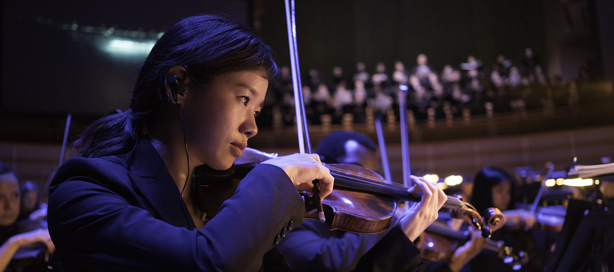 Frost School's Henry Mancini Orchestra student playing the violin during a performance